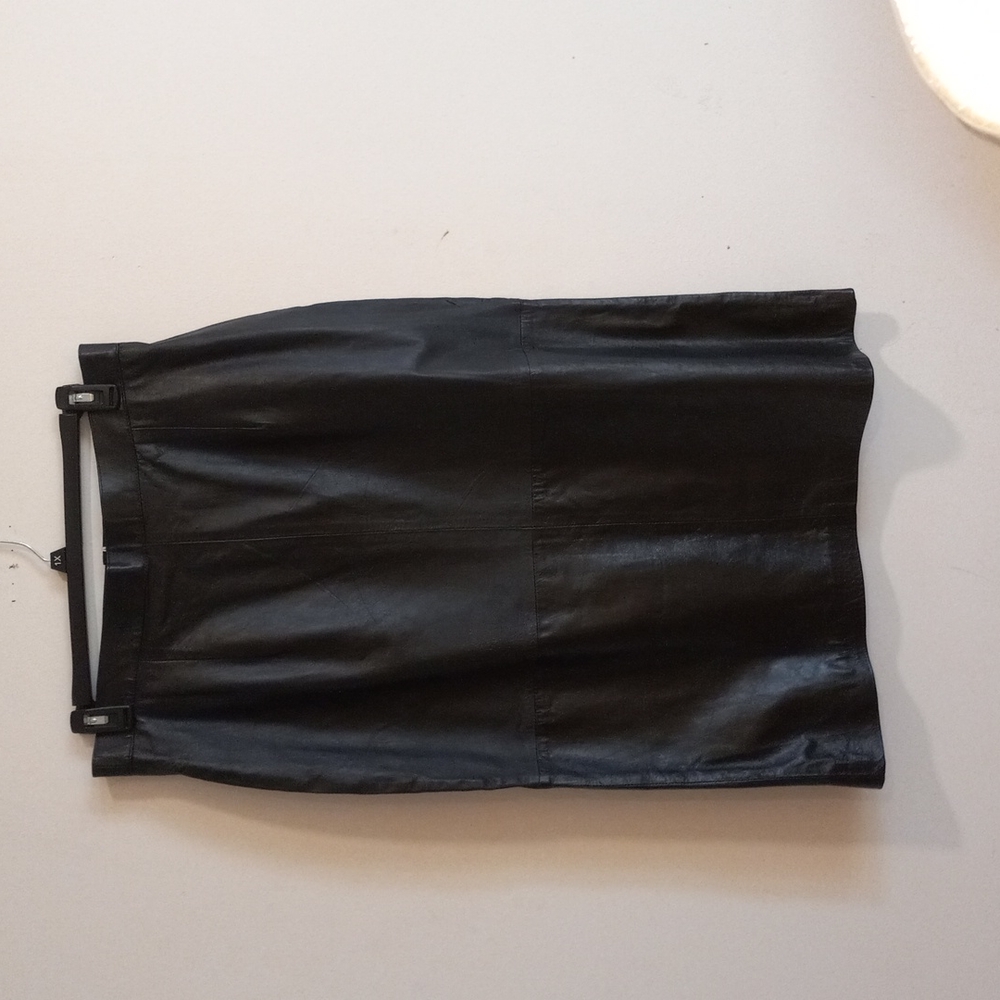 Woman's black leather skirt.
